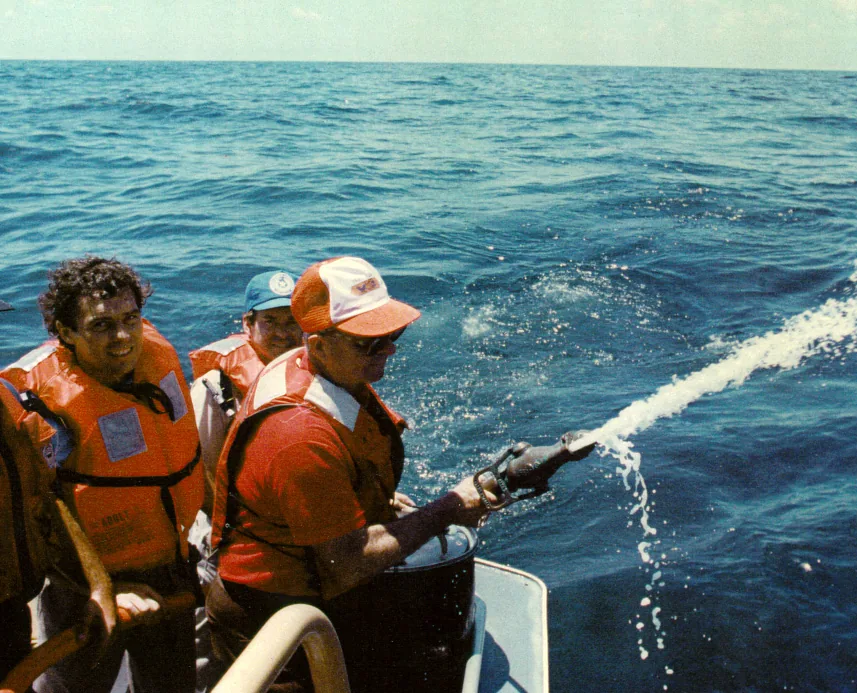 Spraying microbial product from a boat at the 1990 Mega Borg oil spill